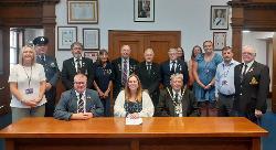 Cllr Susan Wallwork, centre, signs the covenant with representatives of the council and Armed Forces Community.