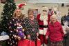 Santa with Fenland District Council community support officer Hayley Mears (left), Cllr Sam Clark, Golden Age team leader, and Marjorie (Madge) Cotterell (right), widow of the late Cllr Mac Cotterell who founded Golden Age fairs 22 years ago!